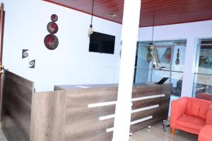 an office with a reception desk and a red chair at Chimpanzee Lodge in Rwumba