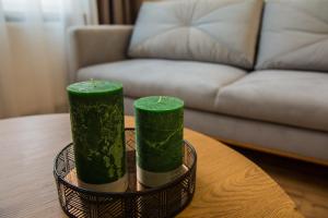 two green candles sitting on top of a table at Piernikowe in Toruń