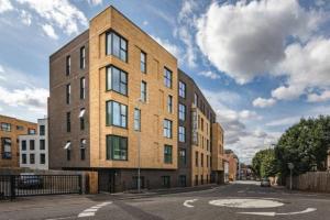 a large brick building on a city street at A beautiful brand new flat 25-minute to London in Luton