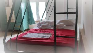 a bedroom with a bunk bed with a red blanket at Calm Point Home in Volissos