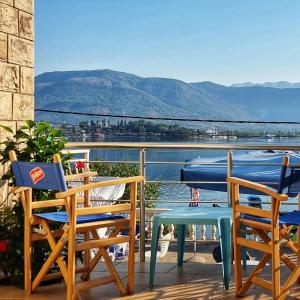 a balcony with chairs and a table and a view of the water at Luxury Apartment Maja in Tivat