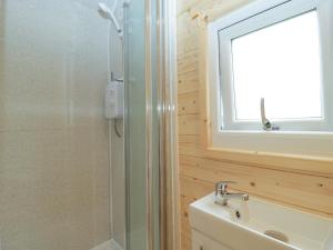 a bathroom with a shower and a sink and a mirror at Beulah in Axbridge