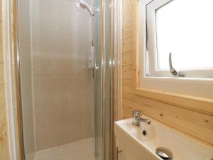 a bathroom with a shower and a sink at Suffolk in Axbridge