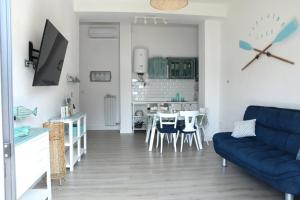 a living room with a blue couch and a table at Paradise Lake in Castro
