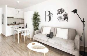 a living room with a couch and a table at Holyhome premium 102 in Costa Teguise +7 photos