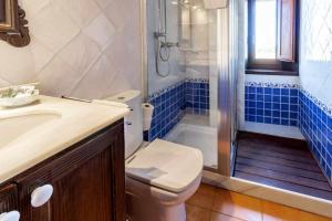 a bathroom with a toilet and a sink and a shower at Ermita de Santa Llúcia - Casa rural histórica in Tonya +27 photos
