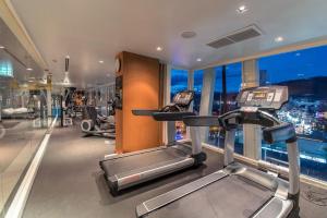 a gym with two treadmills in a building at ASHLEE Hub Hotel Patong in Patong Beach