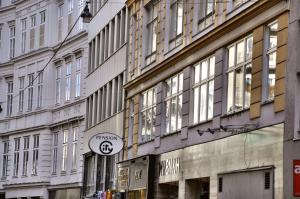 a building with a sign on the side of it at City Pension Stephansplatz I Self Check In in Vienna