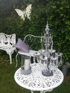 a white table with a tea set on top of it at La grange de Livia in Ferrière-la-Grande