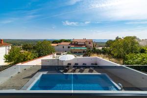 a swimming pool on the roof of a house at Villa Sea View Mandriol in Barbariga
