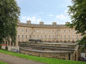 a large building with a fountain in front of it at Ardeevin Cottage in Buxton