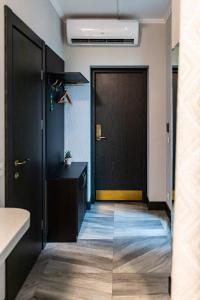 a corridor of an office with a black door at Customs House Hotel & SPA in Rostov on Don