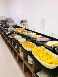 a buffet line with many different types of food at Hotel Estrela da Agua Fria in Sao Paulo