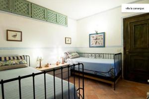 villa la camargue في جيتا: غرفة نوم بسريرين وطاولة فيها