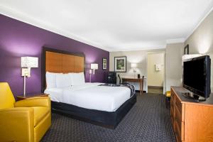 a hotel room with a bed and a television at La Quinta Inn by Wyndham San Marcos in San Marcos