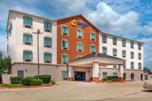 a large building with a clock on the front of it at Comfort Inn Near UNT in Denton