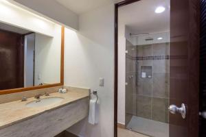 a bathroom with a sink and a shower at Cozumel Hotel & Resort Trademark Collection by Wyndham in Cozumel