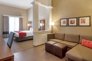 a hotel room with a couch and a bed at Comfort Suites St George - University Area in St. George