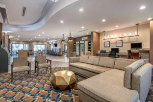 a living room with a couch and a table at Comfort Suites Fort Lauderdale Airport & Cruise Port in Dania Beach