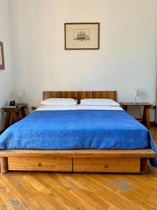 a bedroom with a bed with a blue blanket at Mare Blu in Sapri