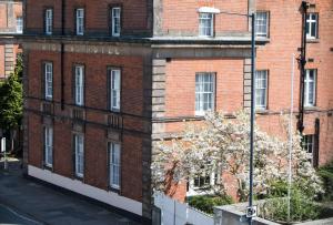 a red brick building with a sign on it at Derby Midland Hotel, BW Signature Collection in Derby
