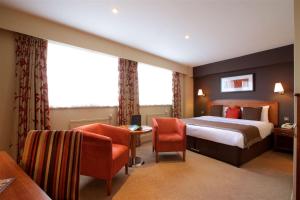 a hotel room with a bed and two chairs at Birmingham Strathallan Hotel, BW Signature Collection in Birmingham