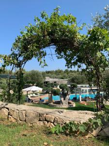 - une vue sur un complexe avec une piscine et un arbre dans l'établissement Casetta Letizia, à Ostuni