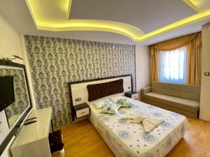A bed or beds in a room at Yalcin Hotel & Villas