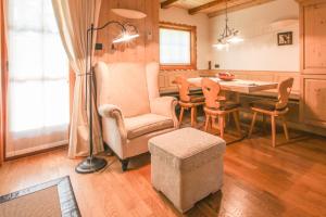 a living room with a dining room table and chairs at Villa Pokljuka in Zgornje Gorje