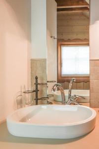 a white sink in a bathroom with a window at Villa Pokljuka in Zgornje Gorje +53 photos