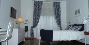 1 dormitorio con cama, escritorio y ventana en Apartment Oltremarestudios, en Nápoles
