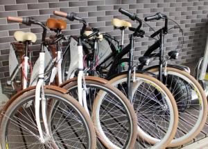 a row of bikes parked next to a wall at Apartament Sea Planet Mielno Centrum - parking w cenie pobytu in Mielno