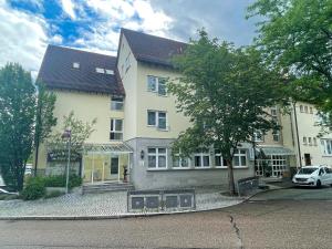 a white car parked in front of a building at Hotel Altbacher Hof in Altbach