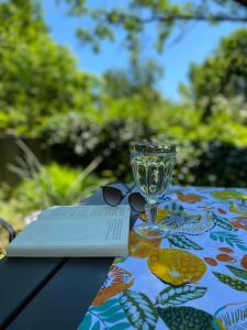 a table with a book and a wine glass on it at Ferienwohnung miraBelle in Erbach im Odenwald