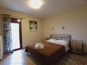 A bed or beds in a room at Queen of Orliaka