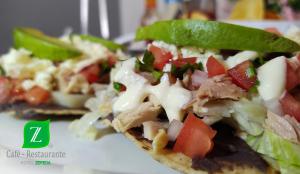 a sandwich with meat and vegetables on a plate at Hotel Zepeda in Ocosingo