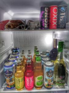 einem offenen Kühlschrank mit vielen Flaschen Bier in der Unterkunft Identity By Nights & Smiles in Tuzla