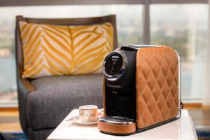 a camera sitting on a table next to a coffee cup at Golden Sands-Dubai Creek in Dubai