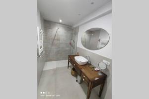 a bathroom with a sink and a mirror at Un balcón sobre el Rio Sella in Ribadesella +32 photos