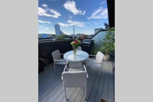 a patio with a table and chairs on a balcony at Riverside Exec Apartment with Balcony - SECC/HYDRO in Glasgow