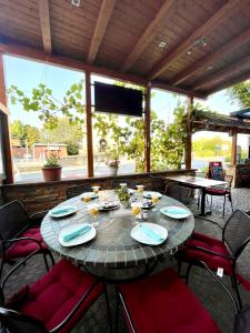 a table in a patio with chairs and a television at zum weißen Ross in Limburg an der Lahn