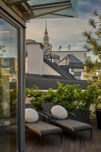 a balcony with two benches and a view of a city at H15 Boutique Hotel in Warsaw