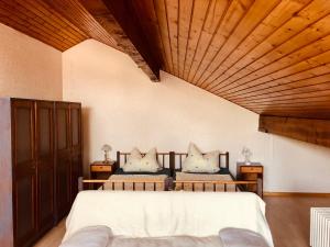 a bedroom with two beds and a wooden ceiling at Haus Koch in Bad Säckingen