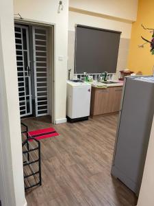 a kitchen with a refrigerator and a large screen at Baojuwu 1 Bedroom Akademik Suites Austin Heights in Johor Bahru