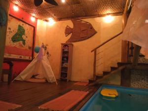 a room with a tent and a swimming pool at Chalé de Charme Mandomai in Ilhabela