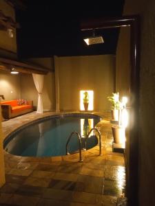 a swimming pool in a hotel room with at Chalé de Charme Mandomai in Ilhabela