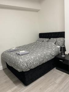a bedroom with a large bed with a black frame at BVapartments-queengate 3 in Huddersfield