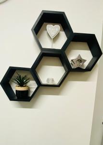 a black wall clock with a heart and stars at BVapartments-queengate 3 in Huddersfield
