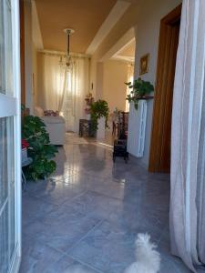 a living room with a tile floor and a hallway at Locanda 130 in Fonni