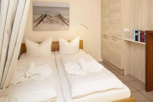 Giường trong phòng chung tại Pure Wonne Fanoe